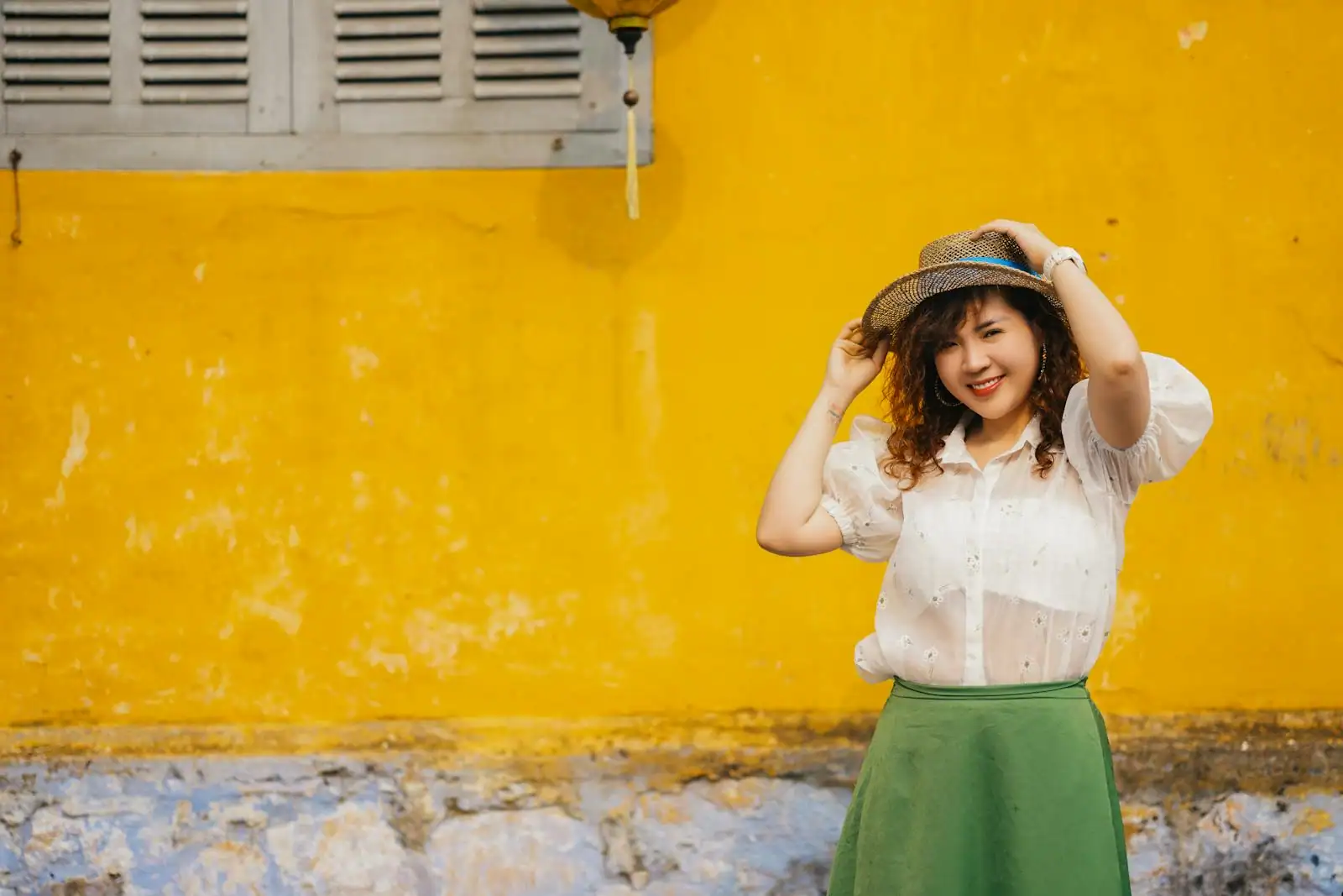 Jeune femme en tenue d'inspiration vintage devant un mur coloré, look rétro assumé et soigné